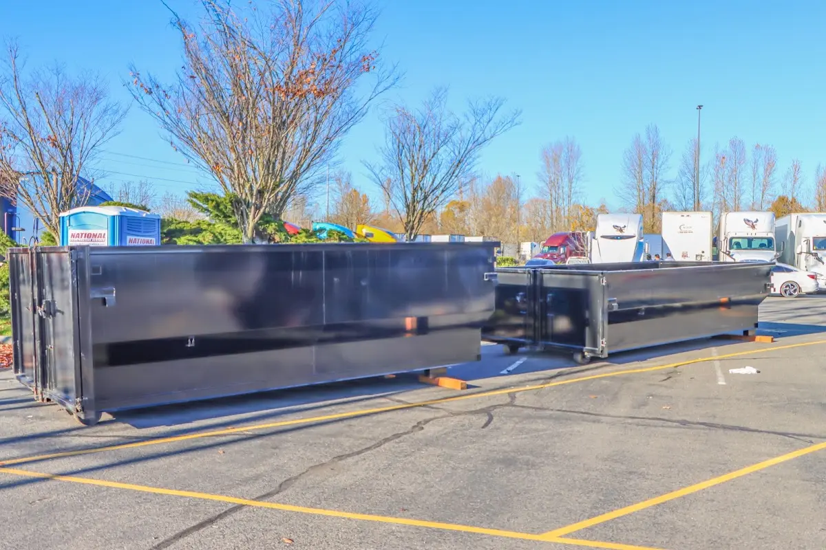 Professional dumpster rental service with roll-off container on residential driveway in Snyder